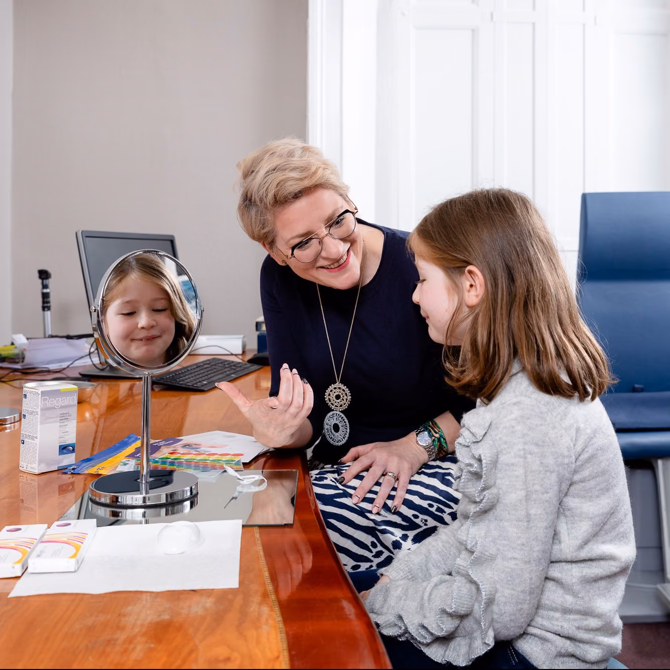 Little Girl Talking To Optom at local opticians
