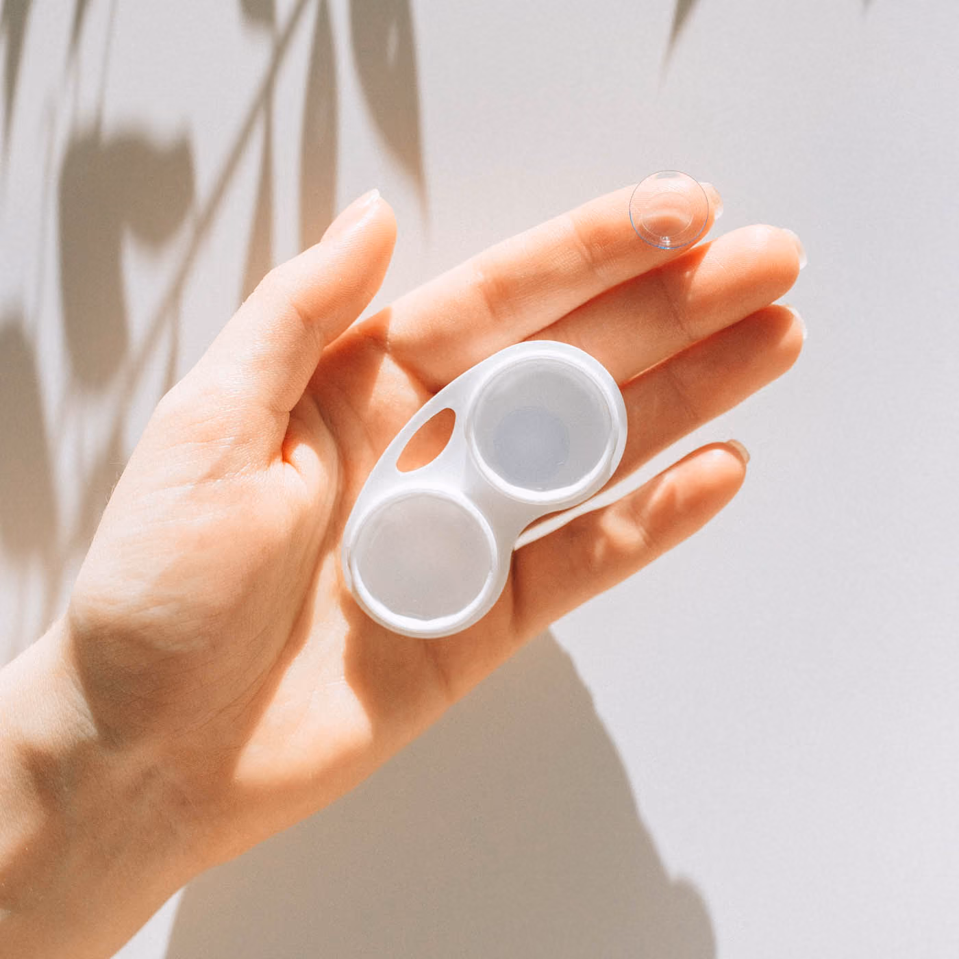 Women Holding Contact Lenses