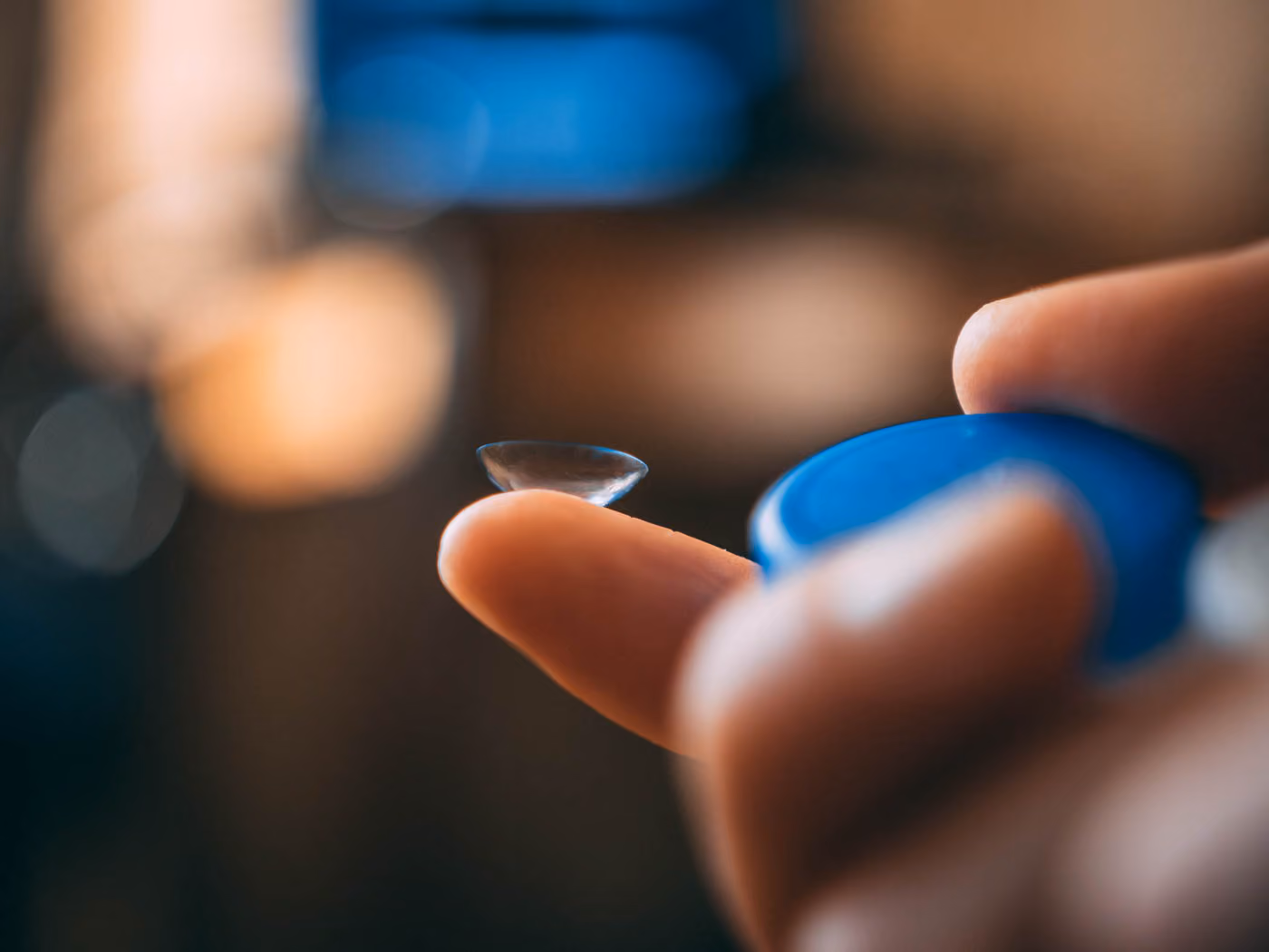 Women Holding Contact Lens