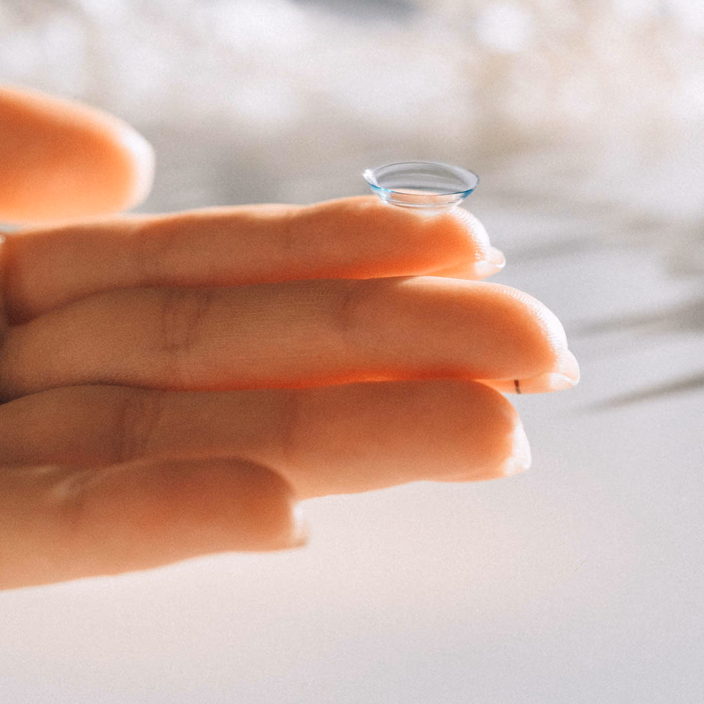 Women Holding Contact Lense