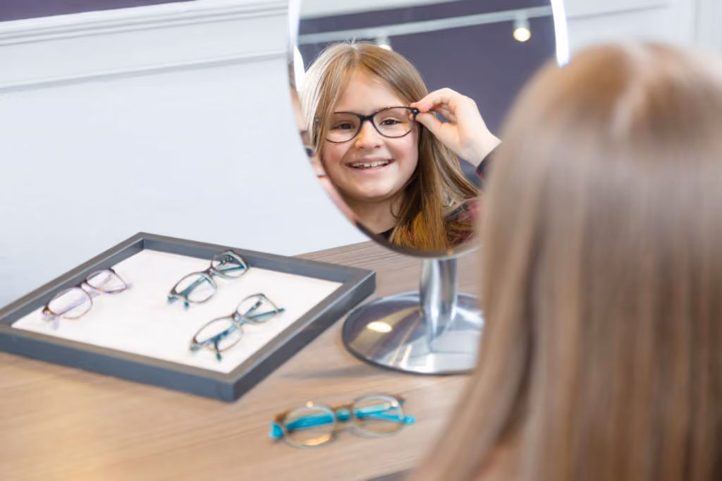 Young Girl Trying On New Glasses