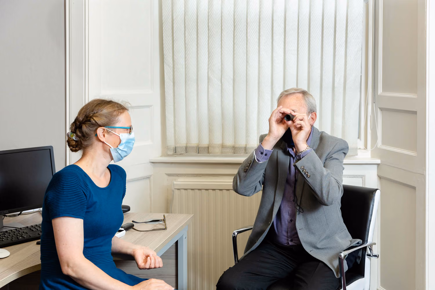 Man holding lens when doing sight test