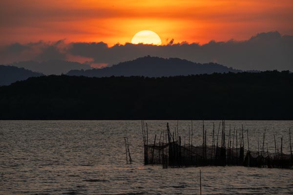 Sunset over Koh Yao Noi with silhouetted hills