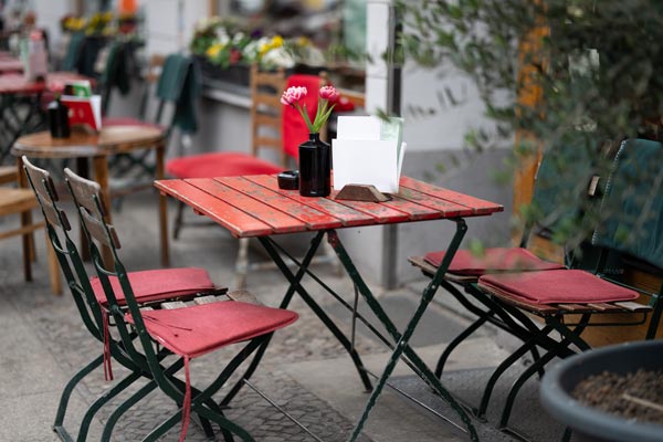 Outdoor cafe table with pink tulips