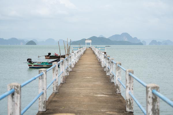 Concrete pier extending into calm sea
