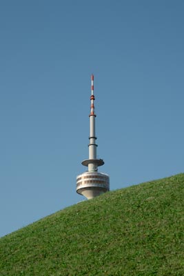 Olympiaturm tower behind grassy hill