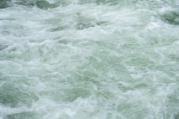 Churning waters of the Eisbachwelle in Munich