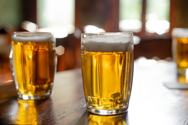 Cold beer glasses on wooden table