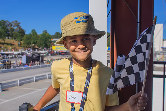 cancer-affected child smiles at Road Atlanta