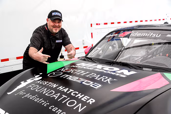 Hixon Motor Sports Team Owner Bryan Hixon shows off Austin Hatcher Foundation logo on #87 racecar