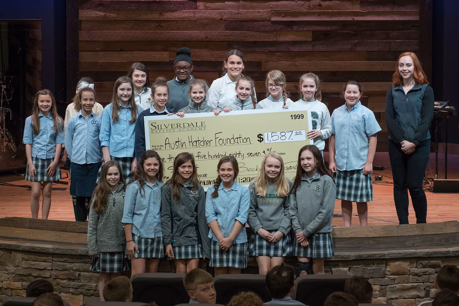 The winning class presents the check to Julia Sharp, Development Coordinator at the Austin Hatcher Foundation
