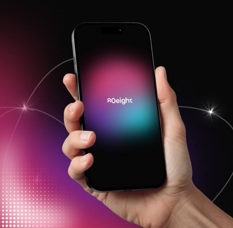 Hand holding a smartphone displaying the Roeight logo on a colorful gradient background with dark surroundings.