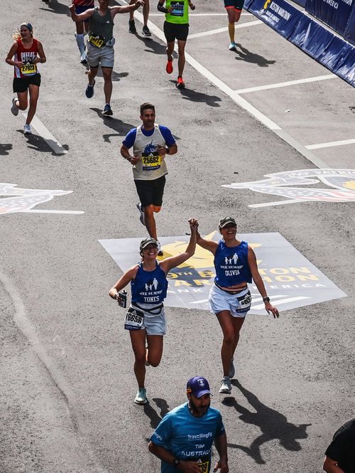 A young child on a climbing wall with helmet and safety gear