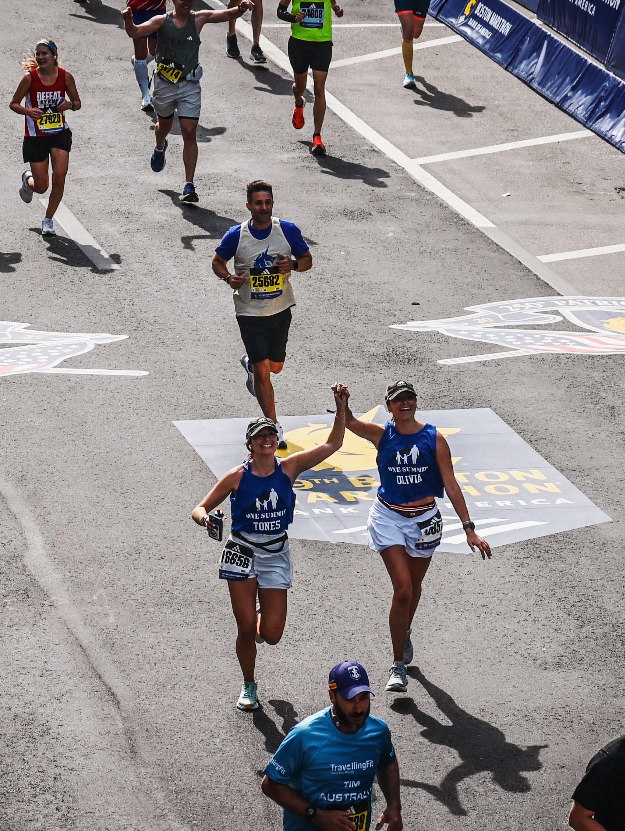 A young child on a climbing wall with helmet and safety gear