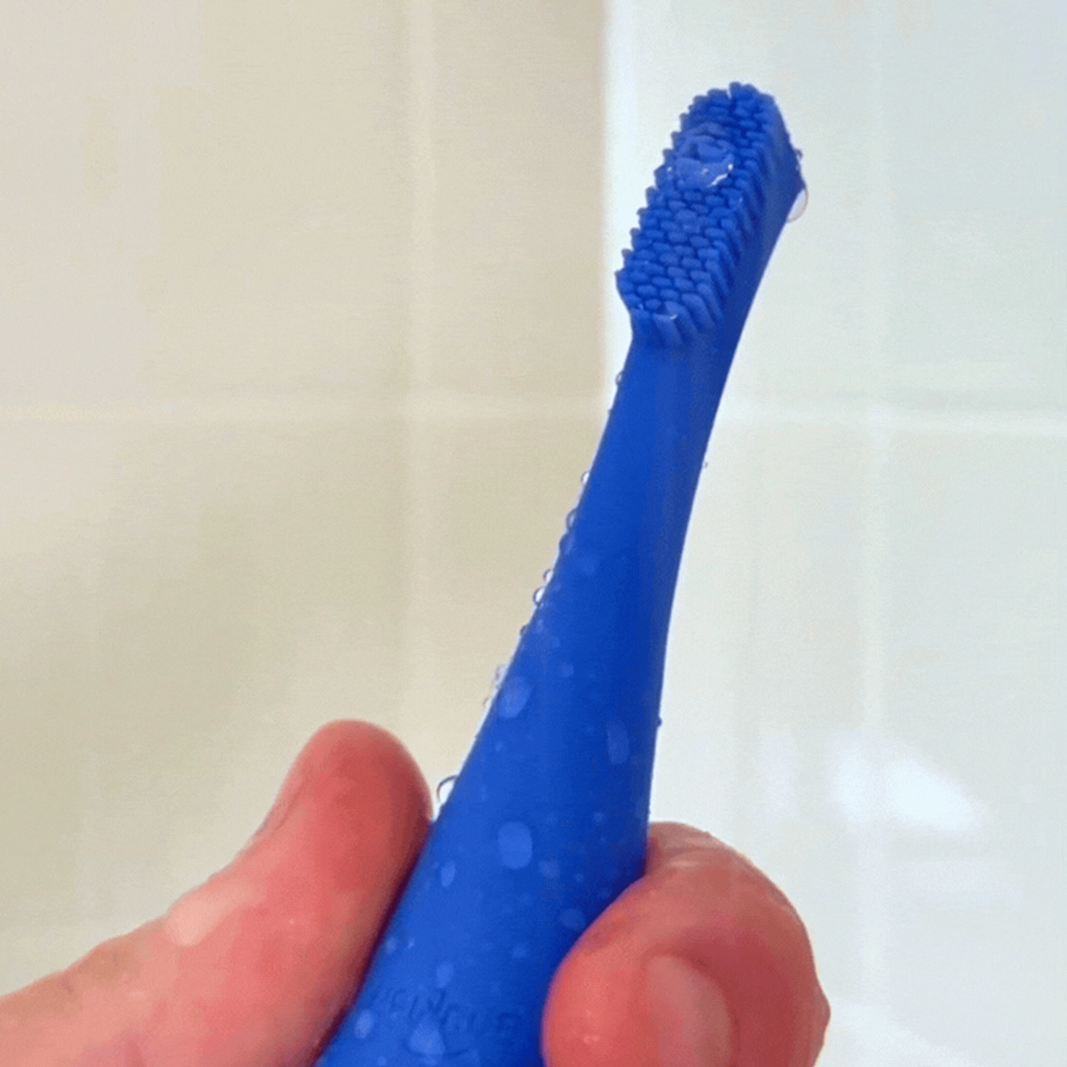Blinkjoy eyelid brush shown waterproof, with device submerged or rinsed under water