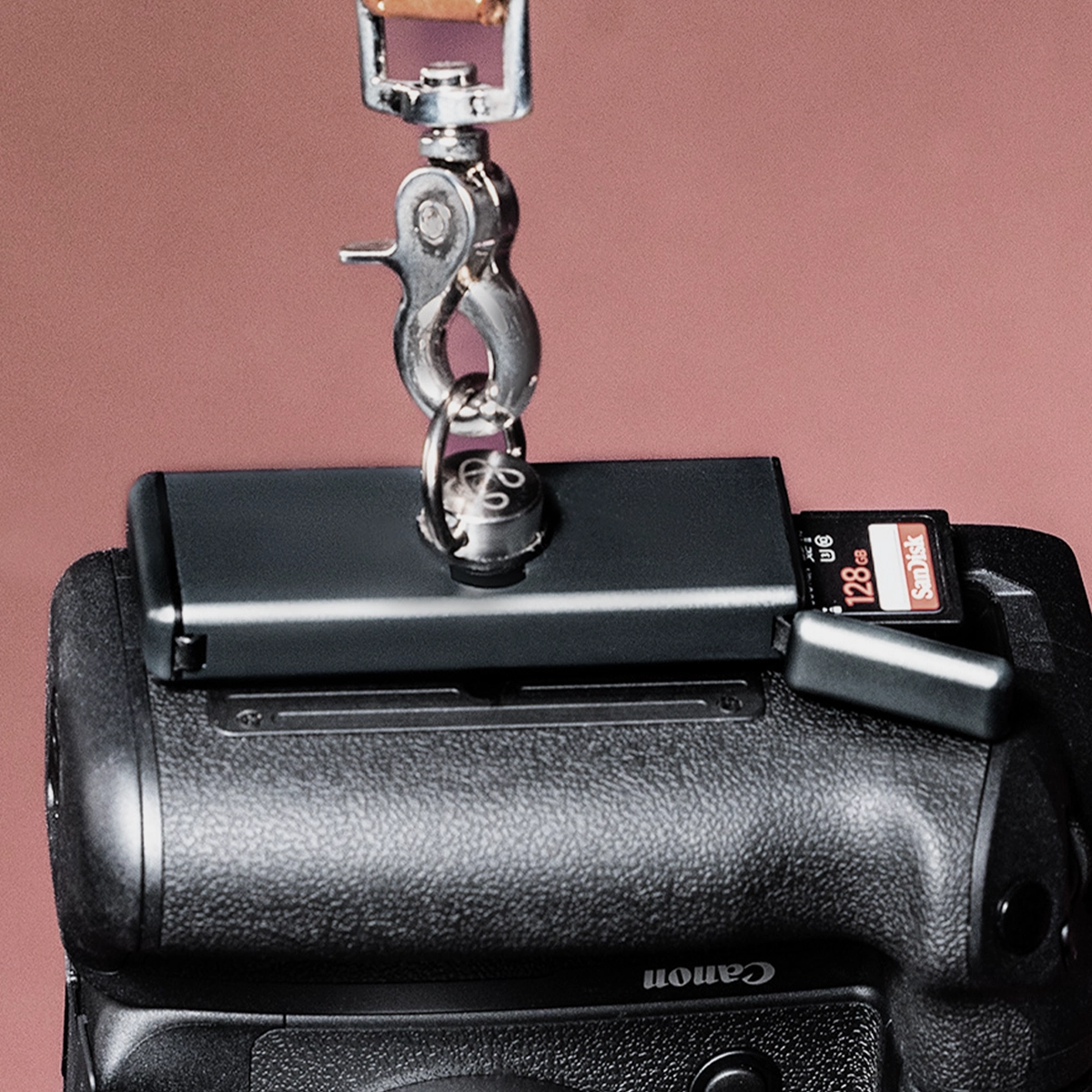Sidekick SD card case supporting a heavy camera on its tripod mount, tech product engineering by Spitfire
