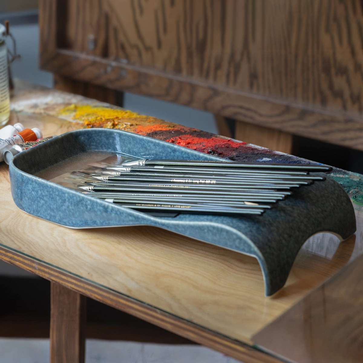 Savvy artist's brush tray holding oil-painting brushes, art-supply product design by Spitfire
