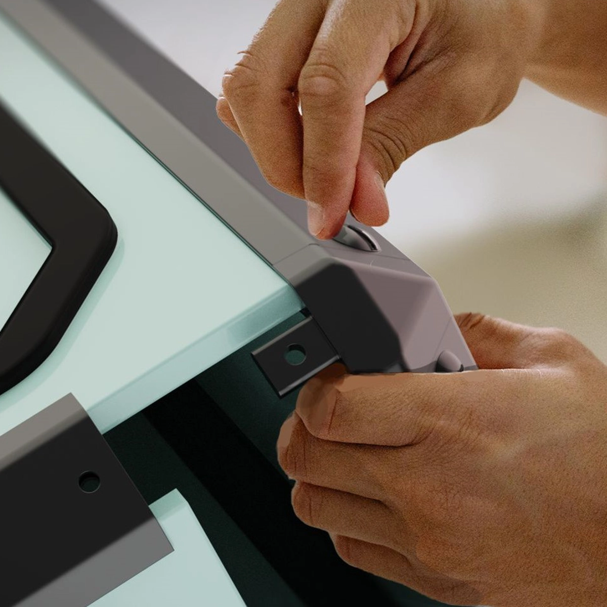 Hands unclipping a corner bracket from a Revival case, the swappable component design that keeps parts out of landfill