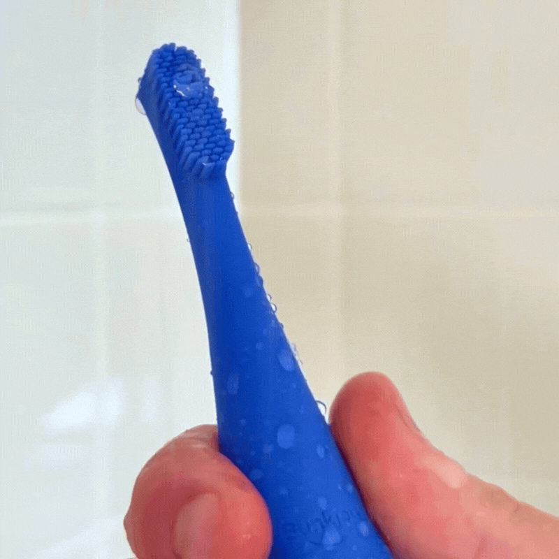 Blinkjoy eyelid brush shown waterproof, with device submerged or rinsed under water