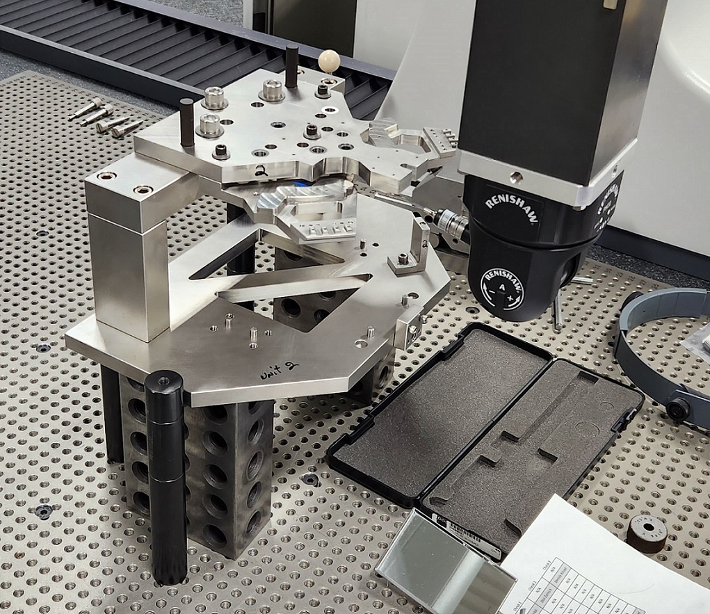 Colorful, intricately cut paper shapes layered and overlapping on a dark surface.