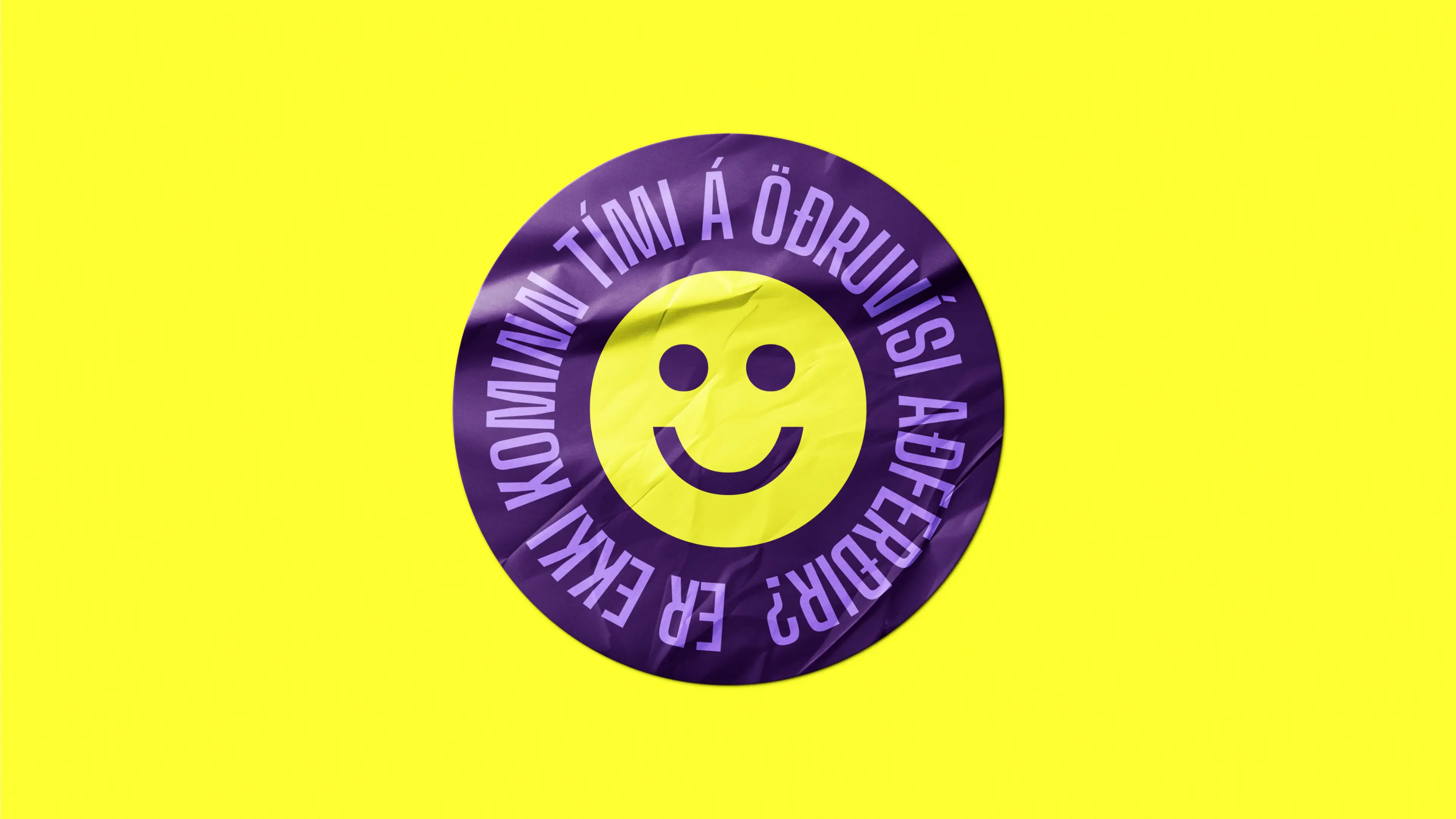 Purple sticker on yellow background, featuring a smiling face and Icelandic text.