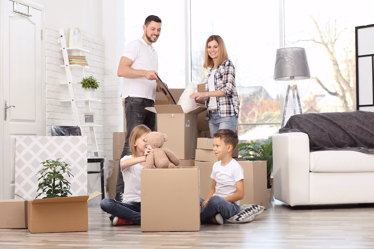 parents and children surrounded by moving boxes