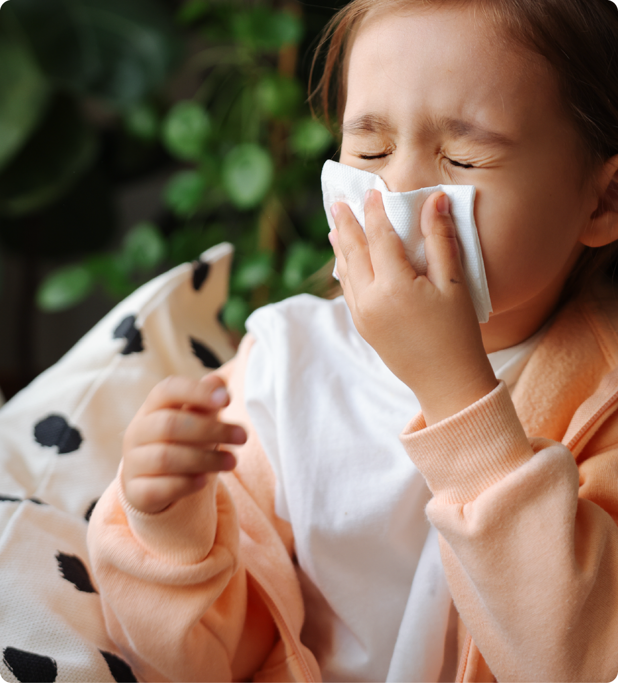 EPH Image: Young girl covering sneeze with tissue paper.