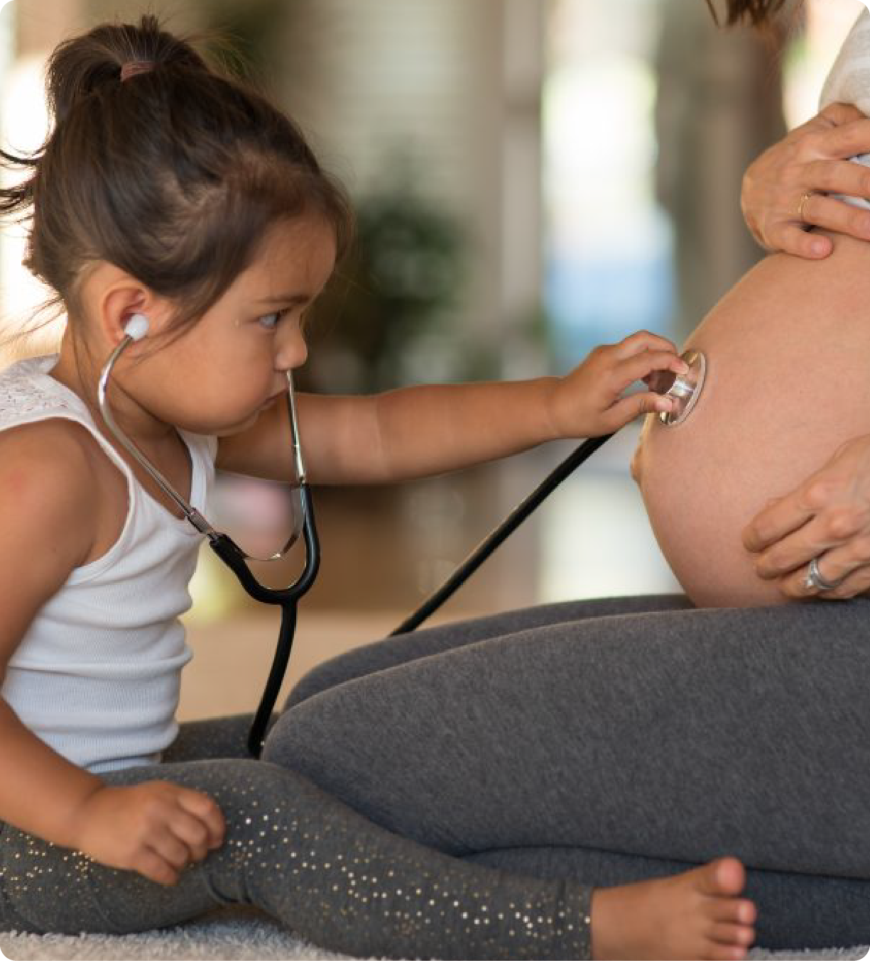 EPH Image: Little girl using stethoscope on pregnant mom's belly