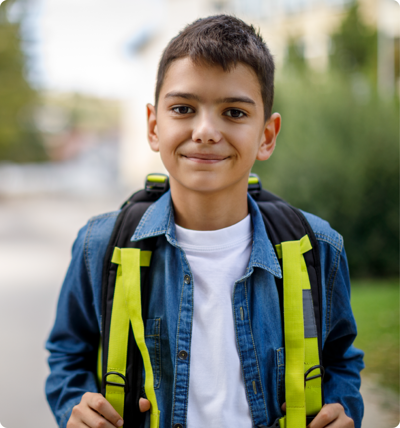 EPH Image: Boy standing and smiling while hollding backpack straps