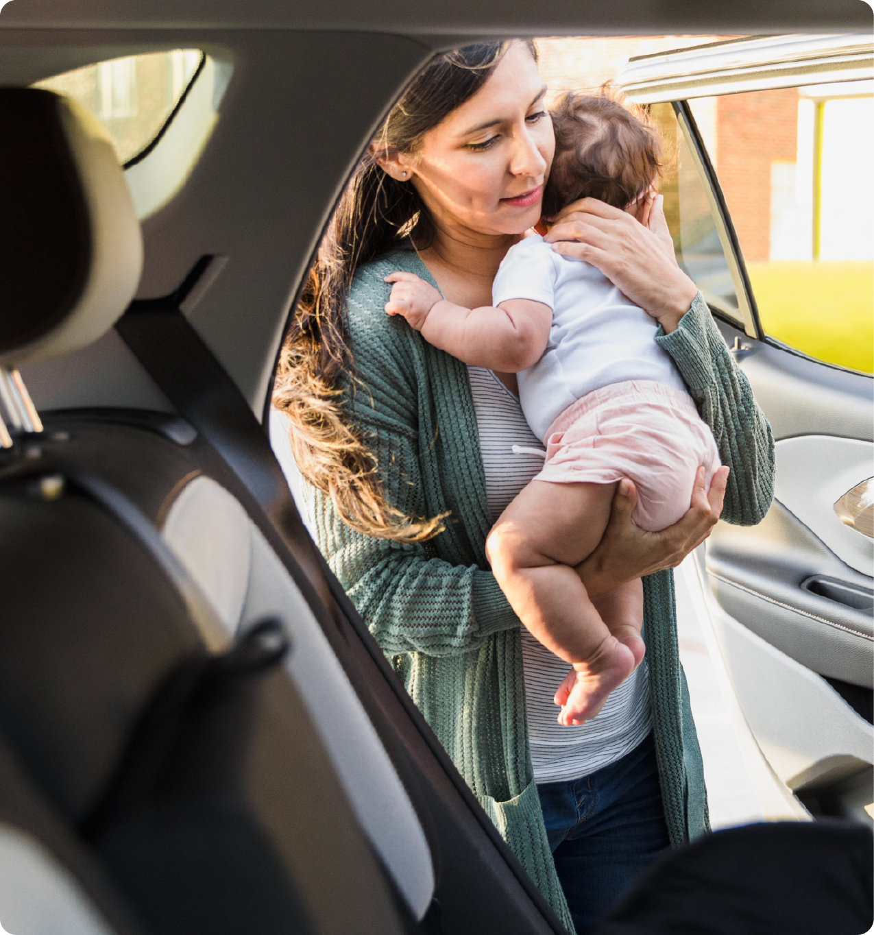 EPH Image: Mom placing baby in a  car seat for transportation