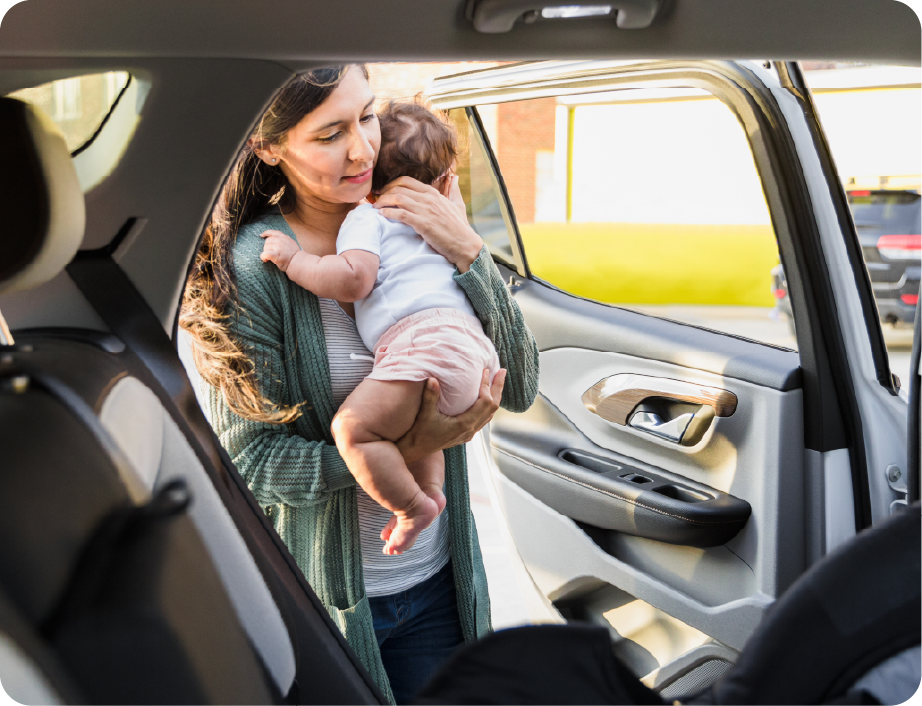 EPH Image: Mom placing baby in car seat for transportation