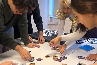 People moving pieces on a table.