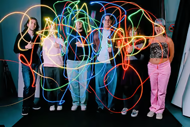 People drawing colored lines in the air.