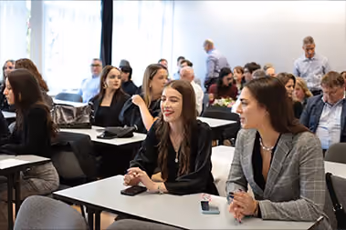 Students in a class talking.