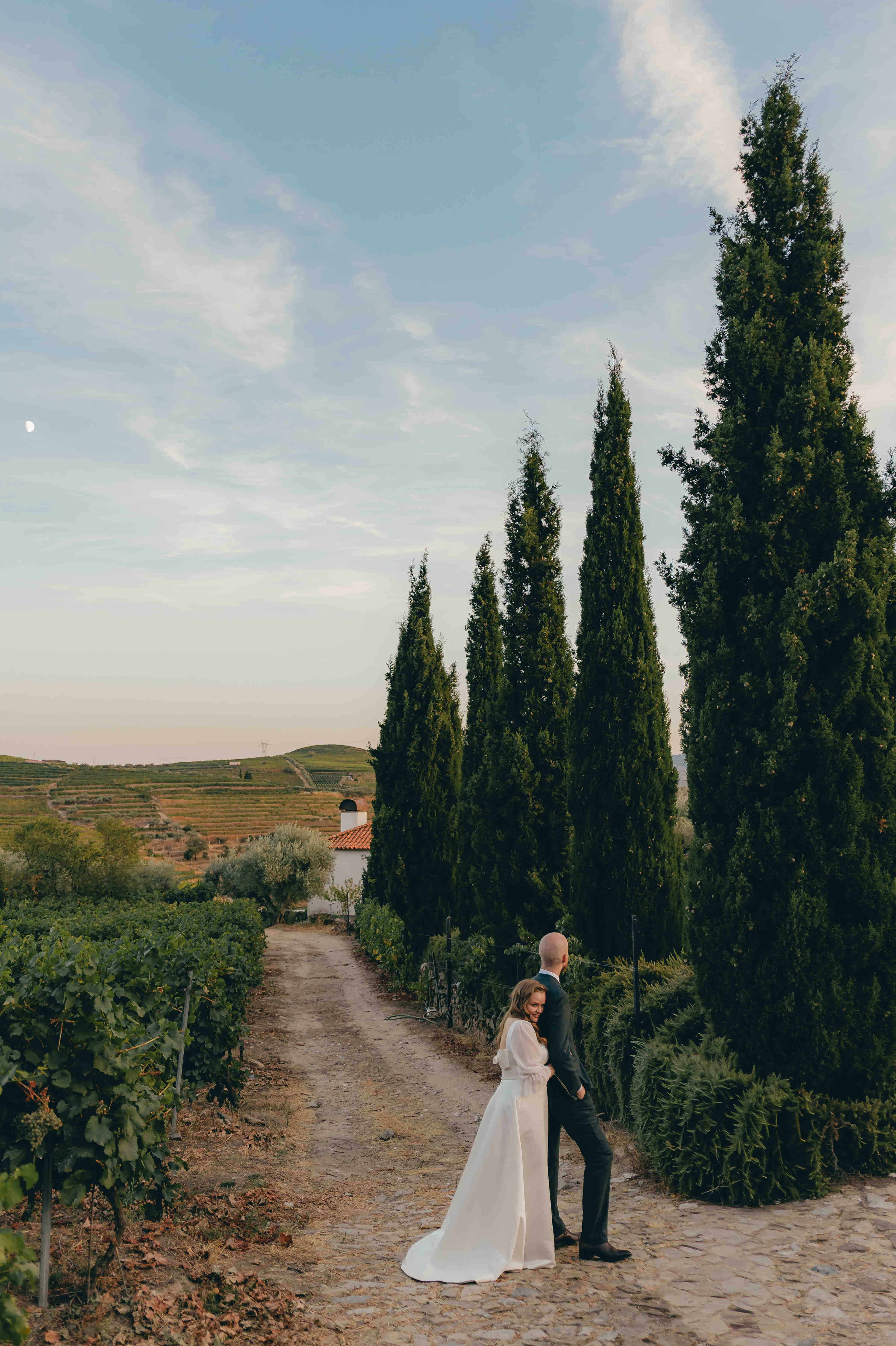 Melissa und Anders vor der Zypressenallee, mit viel Himmel und Landschaft.