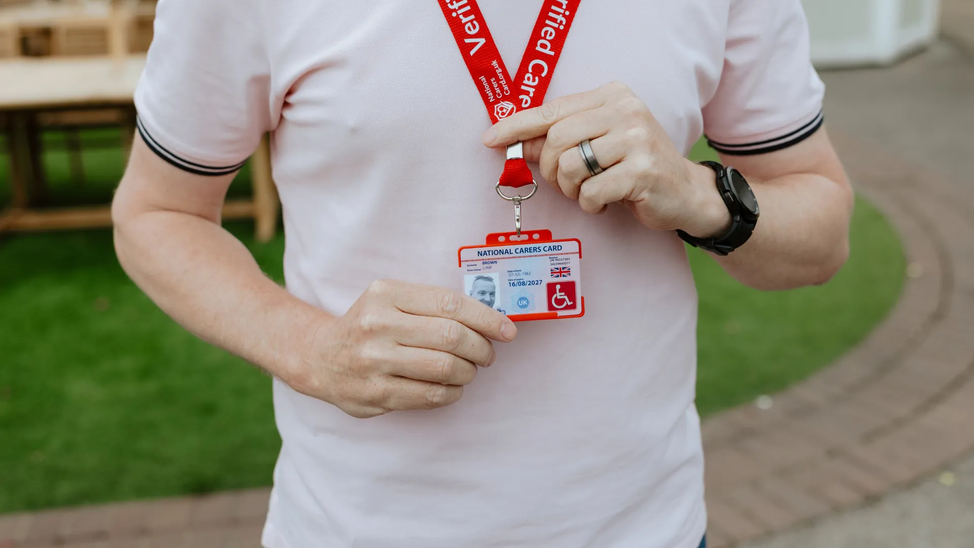 national disability card holder showing her card at a venue for carer ticket access