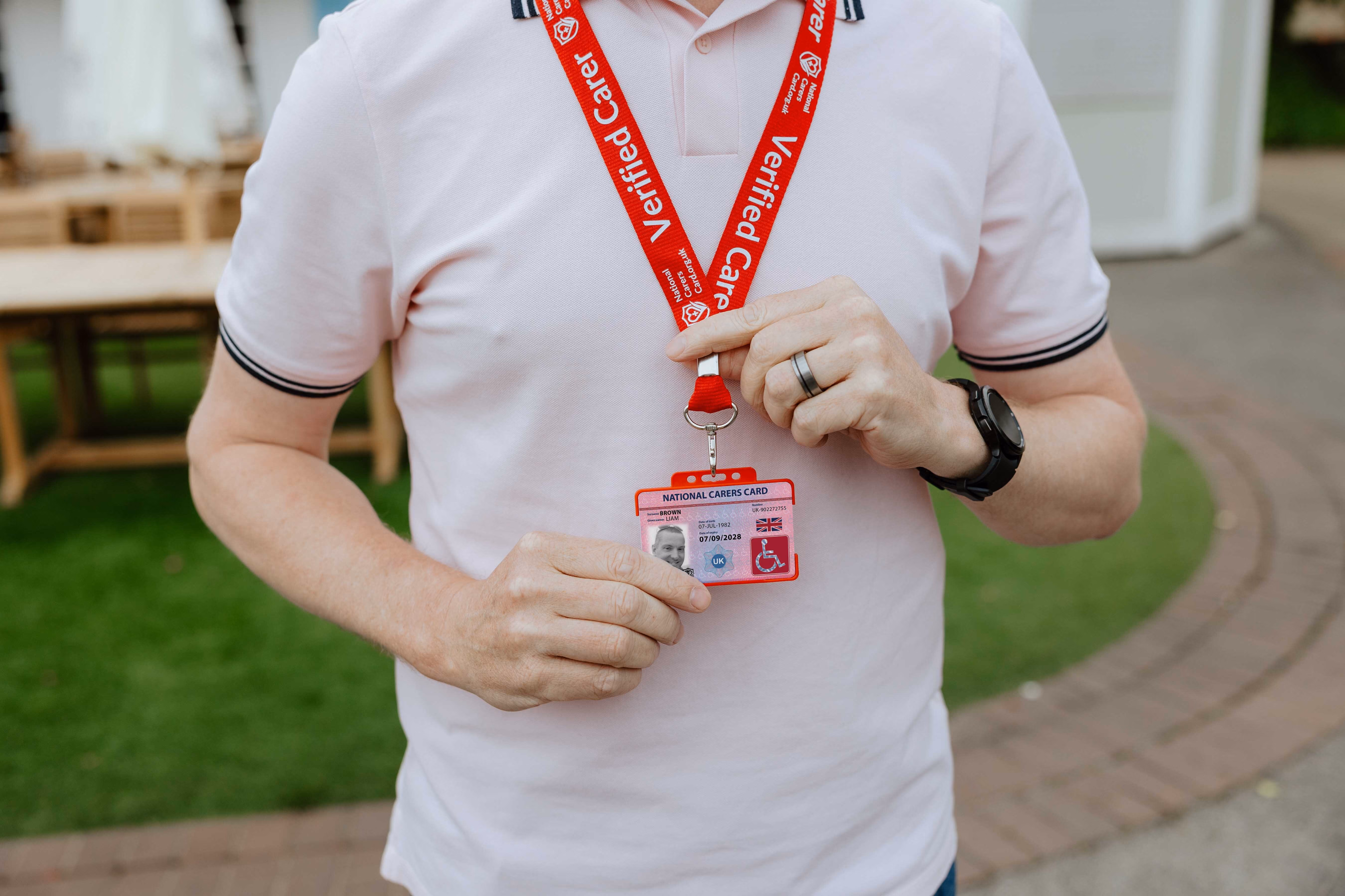 national disability card holder showing her card at a venue for carer ticket access