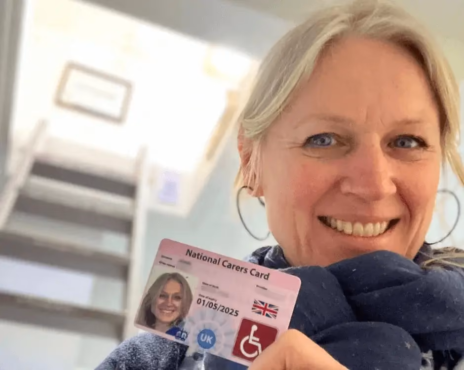 Photo of a National Carers Cardholder holding their carers ID card