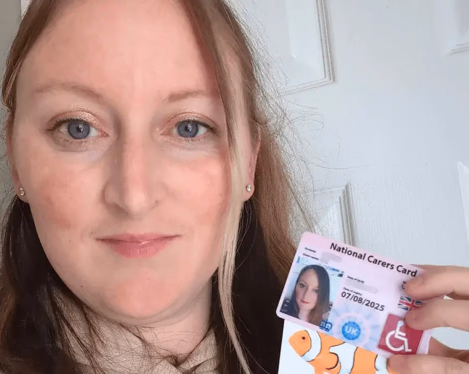 Photo of a National Carers Cardholder holding their carers ID card