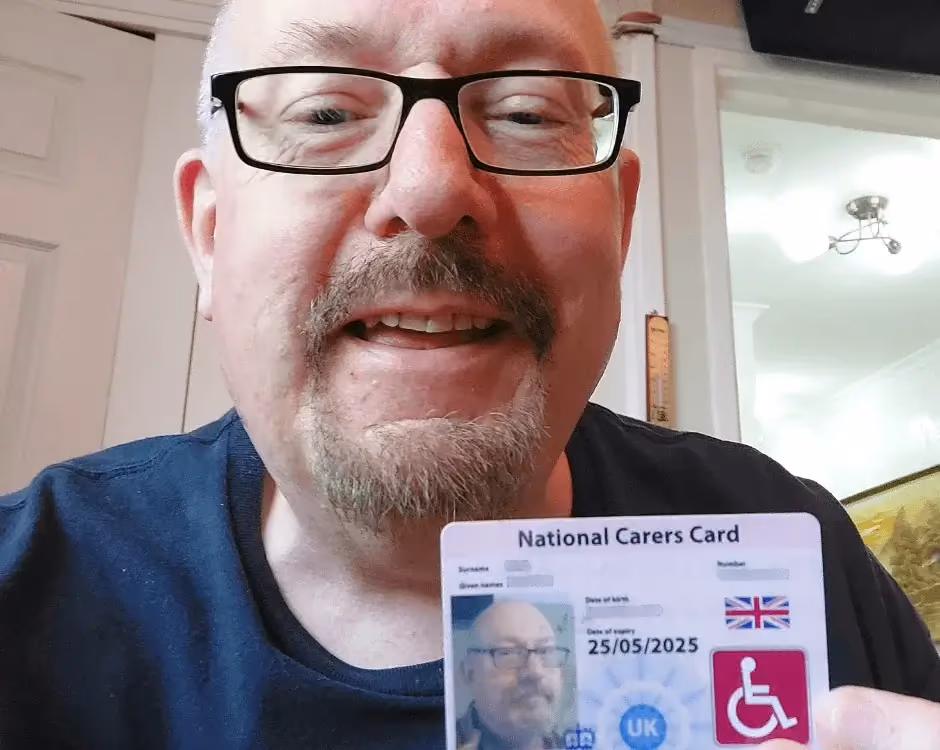 Photo of a National Carers Cardholder holding their carers ID card