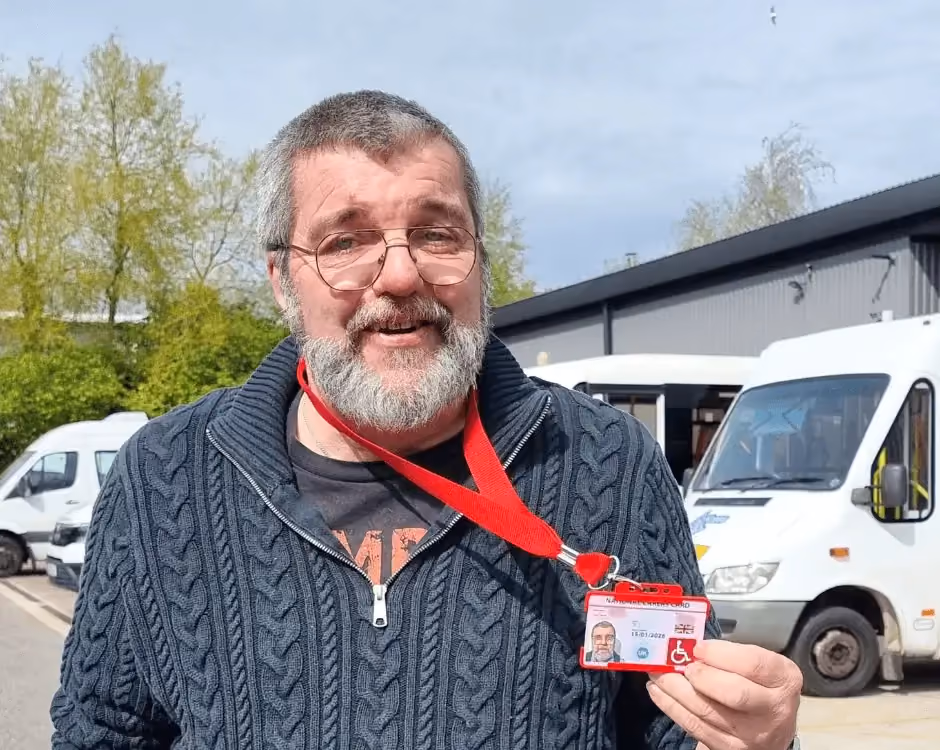 Photo of a National Carers Cardholder holding their carers ID card