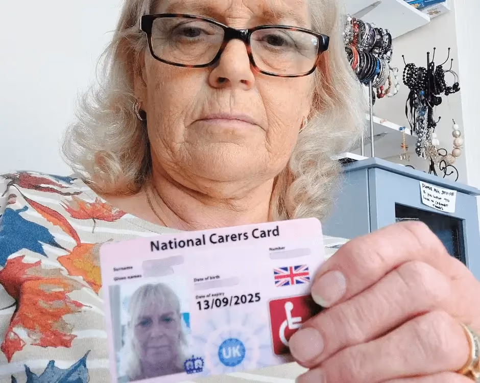 Photo of a National Carers Cardholder holding their carers ID card