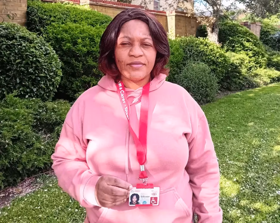 Photo of a National Carers Cardholder holding their carers ID card