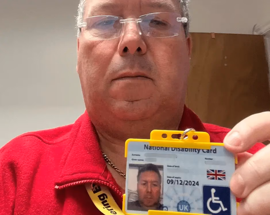 Photo of a National Carers Cardholder holding their carers ID card