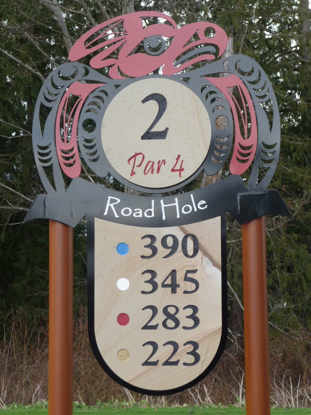 layered tee sign with cut aluminum branding and carved sandstone