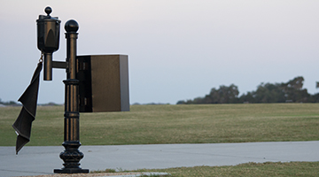 ball washer with trash can on a post