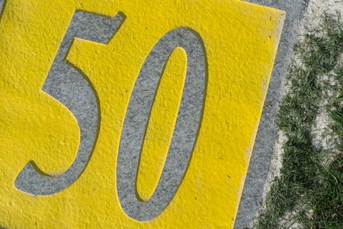 grey granitie fairway marker with yellow painted background