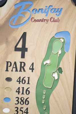 carved sandstone tee sign with hole layout
