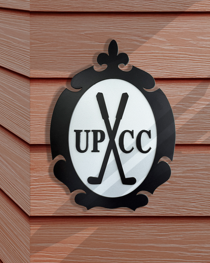 cut metal logo sign on building