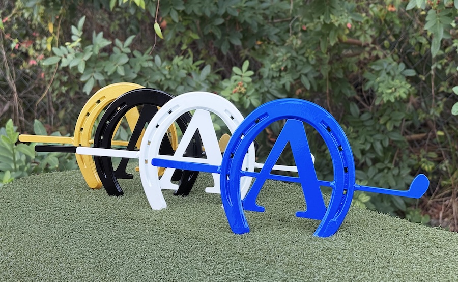 group of four steel horseshoe logo tee markers in golf black white and blue